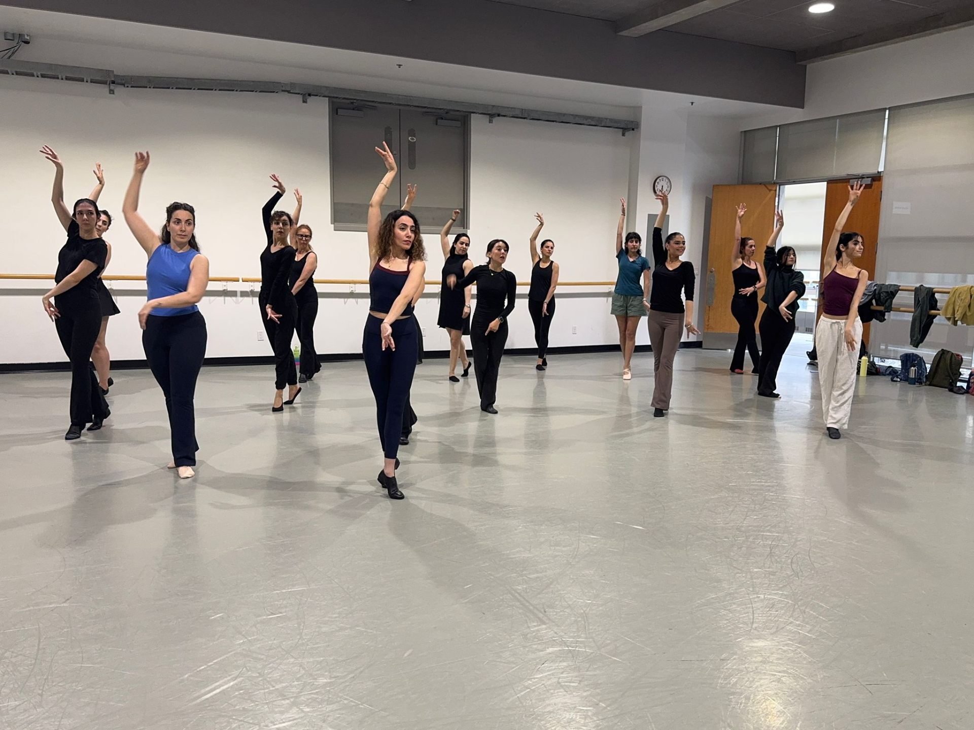 Adult class in session — arms overhead